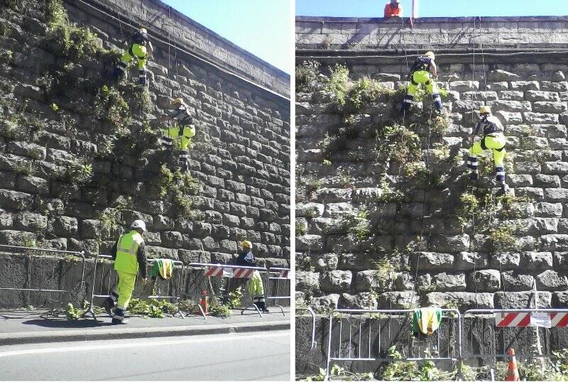 Operai e rocciatori per ripulire il muraglione della stazione